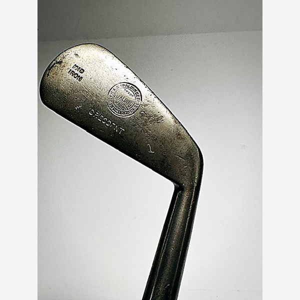 Back of the Spalding Crescent mid-iron showing the circular A.G. Spalding & Bros trademark medallion, hickory golf