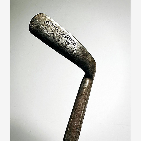Back of the J. Gourlay putter blade showing both oval maker stamps and the offset hosel, hickory golf