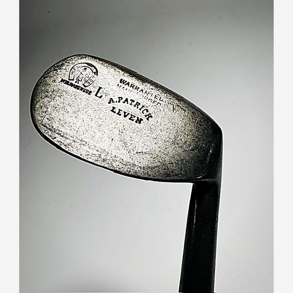 Back of the A. Patrick niblick head showing the Leven stamp, horseshoe cleek mark and Warranted Hand Forged, hickory golf