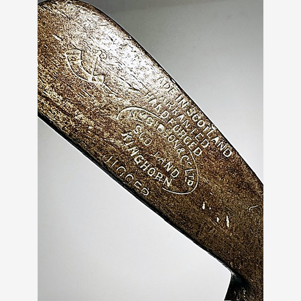 Close-up of the W. Gibson & Co. Ltd Kinghorn hand forged stamp on the hickory golf jigger head
