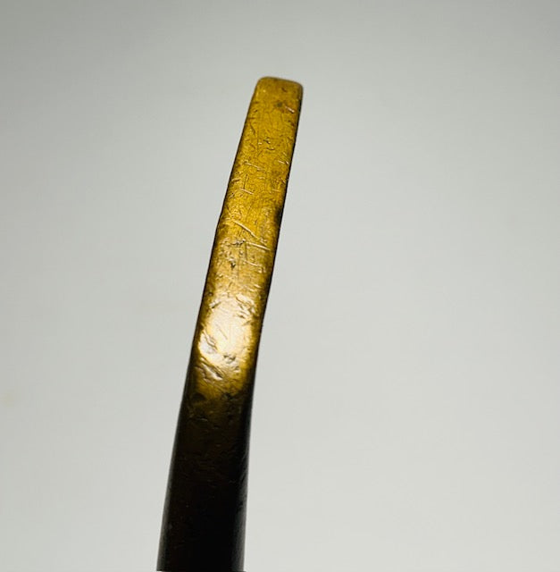 Brass putter sole profile showing golden brass finish and period wear