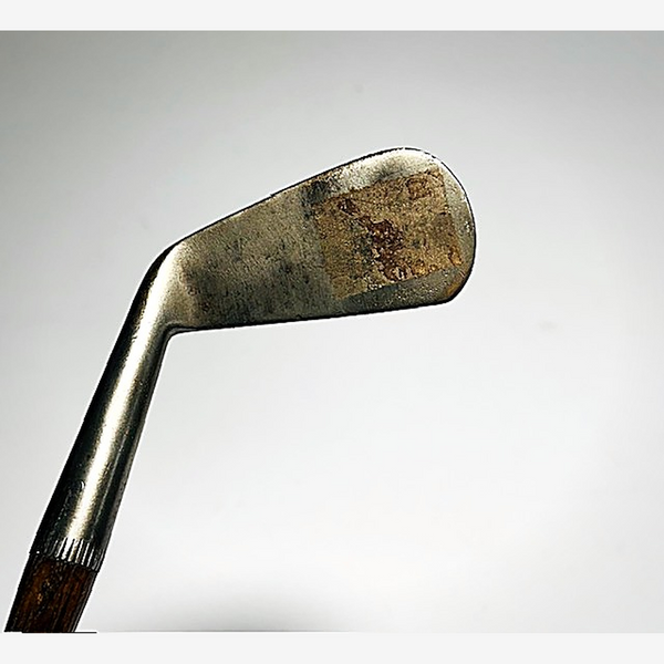 Smooth unscored face of the Spalding Crescent hickory golf mid-iron at address