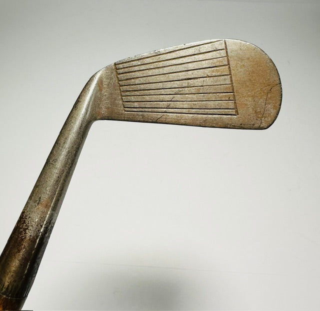 Thomas E. Wilson mid iron hickory golf face with scored lines at address