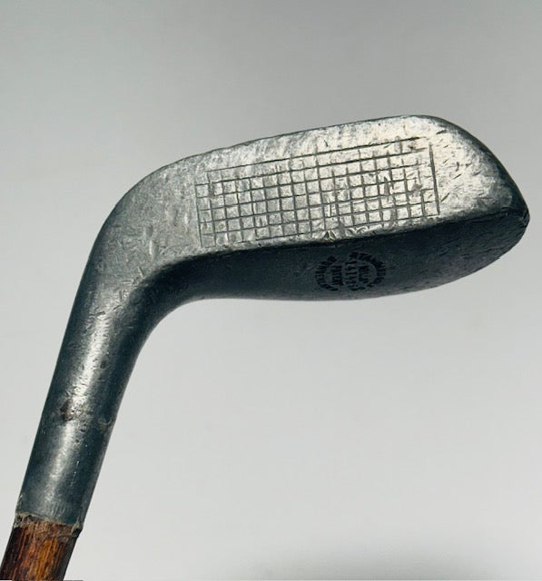Braid-Mills putter gridded scored face at address with Standard Golf cleek mark