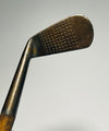 Spalding Gold Medal mashie hickory golf iron dot-punch scored face at address