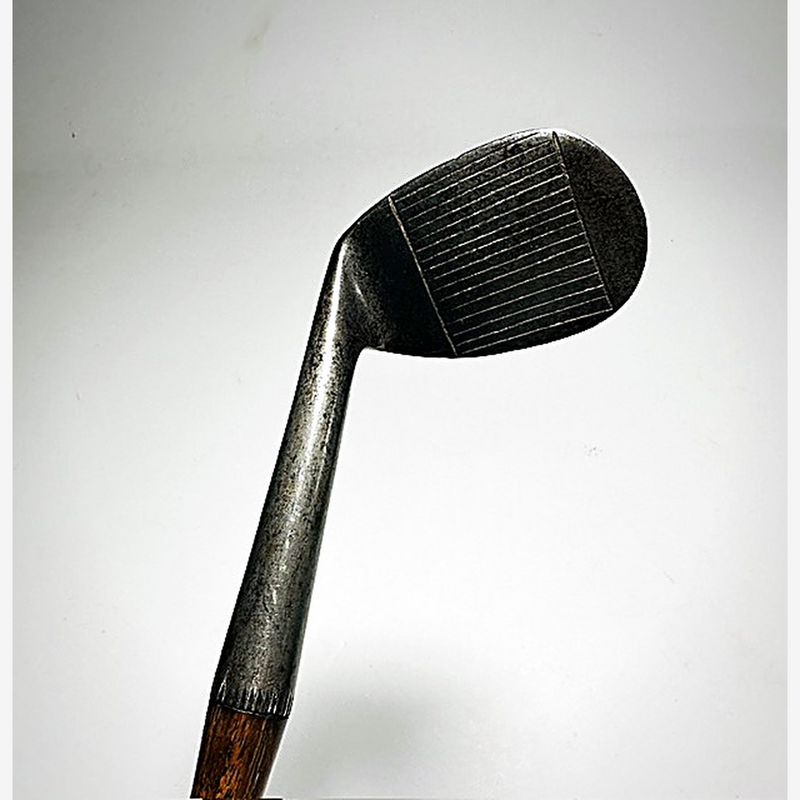 Line-scored face of the A. Patrick Leven hickory golf niblick at address