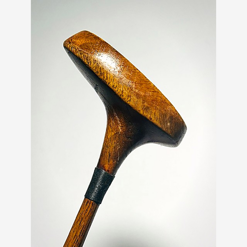 Three-quarter view of the Wright & Ditson mallet head, neck whipping and hickory shaft, hickory golf putter