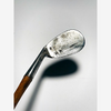 A. Foreman niblick face with dot-punch pattern, hickory golf iron