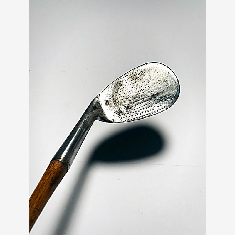 A. Foreman niblick face with dot-punch pattern, hickory golf iron