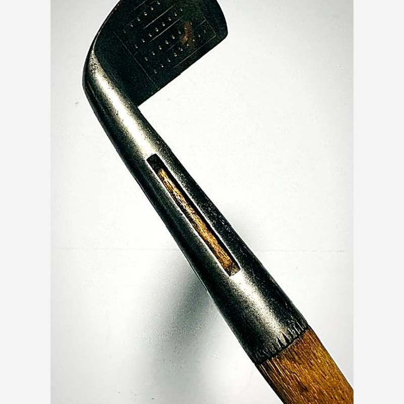 Close view of the slotted hosel on the MacGregor Bobbie iron with hickory visible through the slot