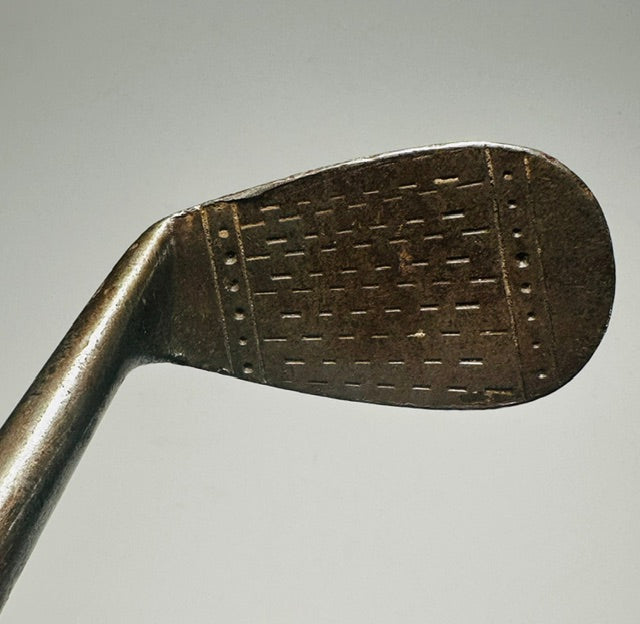 MacGregor Popular mashie-niblick hickory golf face with dot-punch scoring at address