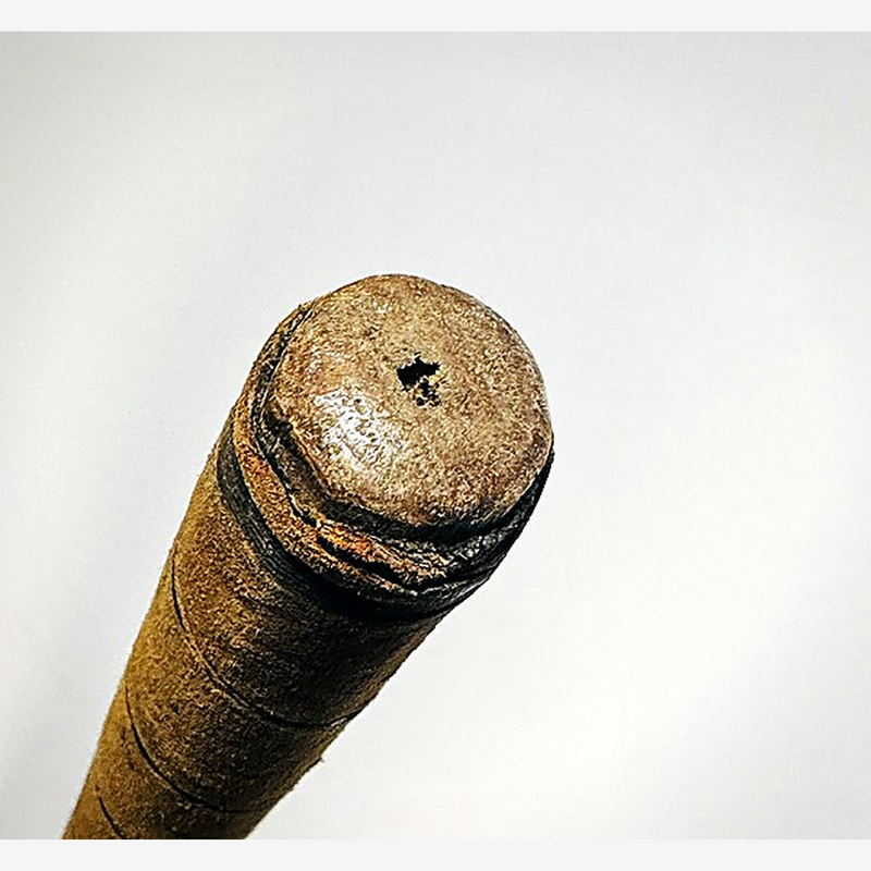 Butt end of the Spalding Crescent hickory golf iron showing the small star-shaped hole in the cap